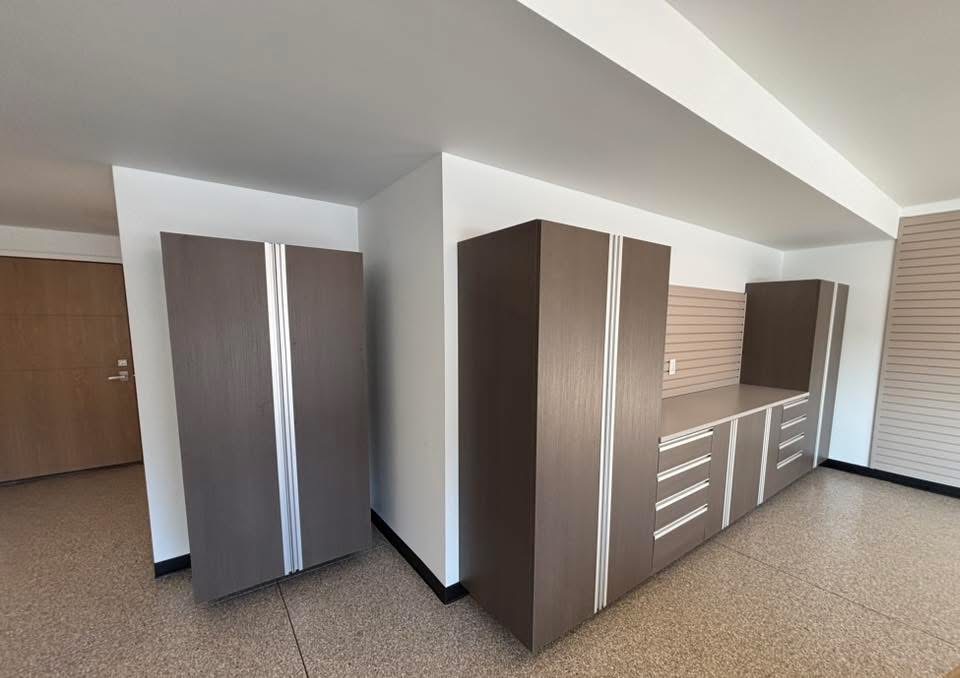 Overhead ceiling storage racks installed over a polyurea-coated garage floor